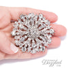 antique rhinestone wedding brooch in hand
